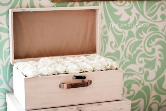 A Mint to Be Bridal Shower decorations, luggage full of white flowers